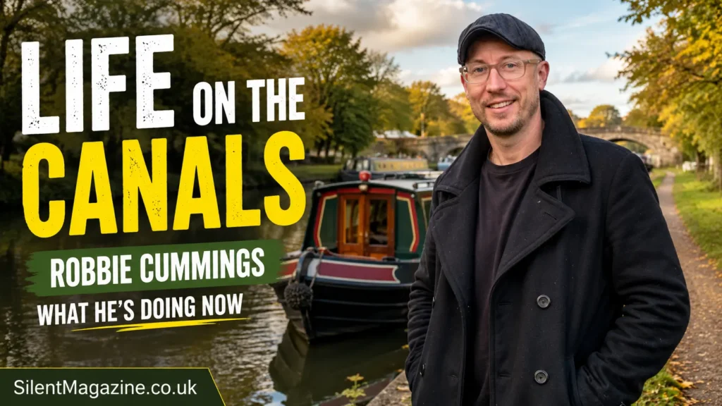 Robbie Cummings standing beside a narrowboat during canal travel in Britain